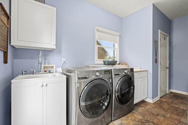 3615 Legacy Dr, Springfield, TN 37172 - laundry area with separate washer and dryer, dark stone finish flooring, baseboards, and cabinet space