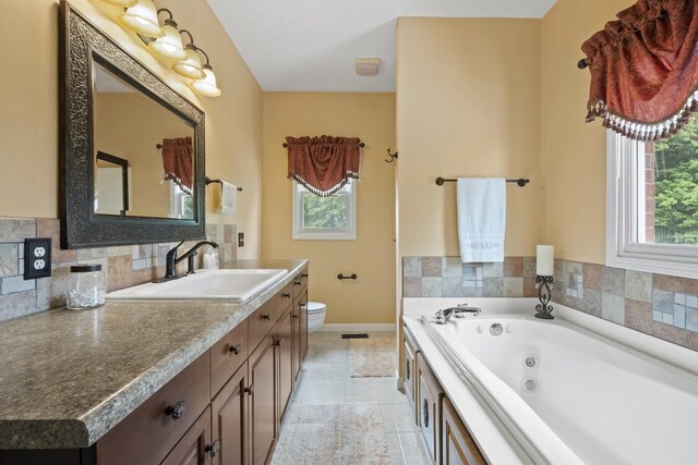3615 Legacy Dr, Springfield, TN 37172 - bathroom featuring vanity, a tub with jets, tile patterned flooring, baseboards, and toilet