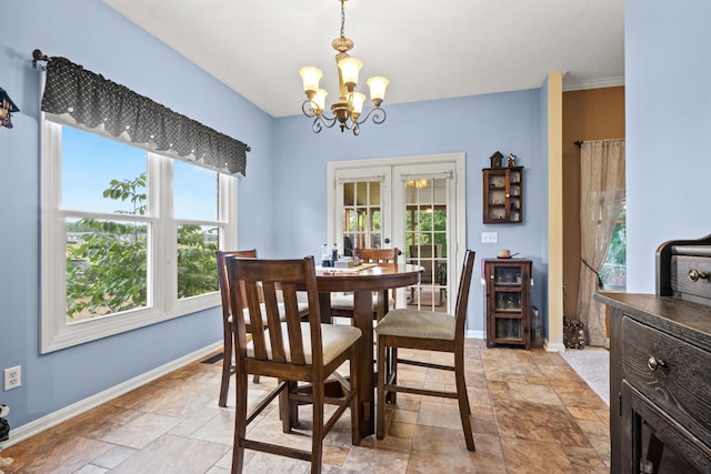 3615 Legacy Dr, Springfield, TN 37172 - dining space featuring a chandelier, baseboards, stone tile floors, and plenty of natural light