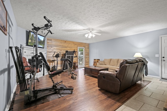 3615 Legacy Dr, Springfield, TN 37172 - workout room with wooden walls, ceiling fan, baseboards, and a textured ceiling