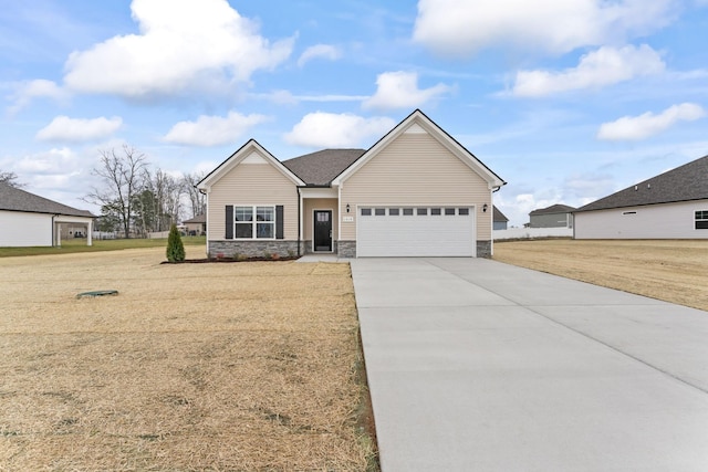 1129 Bluecreek Cir, Murfreesboro, TN 37129 - view of front facade featuring concrete driveway, stone siding, an attached garage, and a front yard