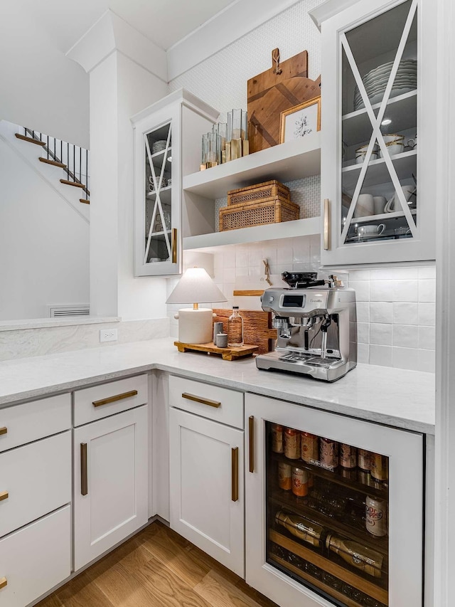 9021 Passiflora Ct, College Grove, TN 37046 - bar featuring beverage cooler, backsplash, stairway, and light wood finished floors