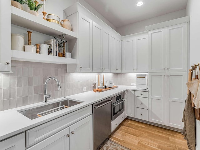 9021 Passiflora Ct, College Grove, TN 37046 - kitchen featuring open shelves, appliances with stainless steel finishes, a sink, white cabinets, and light countertops