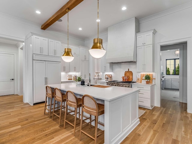9021 Passiflora Ct, College Grove, TN 37046 - kitchen featuring custom range hood, crown molding, light countertops, a sink, and a center island with sink