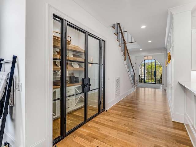 9021 Passiflora Ct, College Grove, TN 37046 - hallway with light wood-type flooring, stairs, baseboards, recessed lighting, and french doors