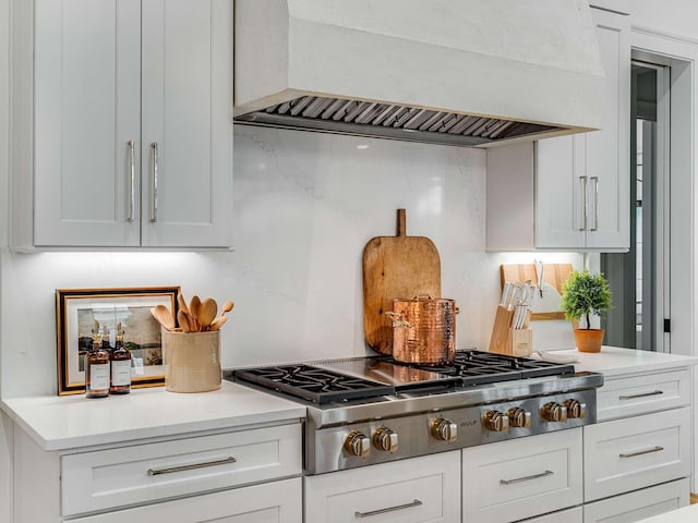 9021 Passiflora Ct, College Grove, TN 37046 - kitchen with custom exhaust hood, stainless steel gas stovetop, white cabinets, and light countertops