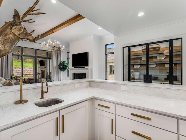 9021 Passiflora Ct, College Grove, TN 37046 - kitchen featuring a sink, open floor plan, light stone countertops, white cabinets, and recessed lighting