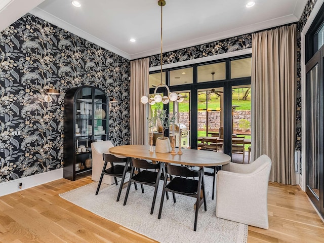 9021 Passiflora Ct, College Grove, TN 37046 - dining room featuring wallpapered walls, crown molding, wood finished floors, recessed lighting, and arched walkways