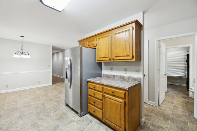 3031 Hartford Dr, Murfreesboro, TN 37129 - kitchen with stainless steel fridge with ice dispenser, brown cabinets, a chandelier, pendant lighting, and baseboards