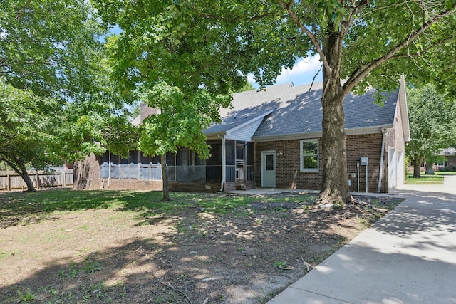 3031 Hartford Dr, Murfreesboro, TN 37129 - view of front of house with a sunroom, brick siding, a garage, concrete driveway, and a shingled roof
