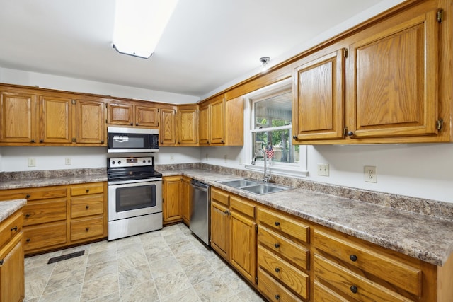3031 Hartford Dr, Murfreesboro, TN 37129 - kitchen featuring stainless steel appliances, a sink, and brown cabinetry