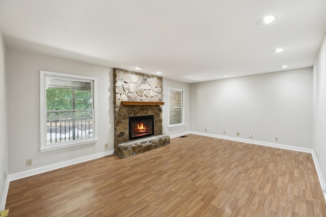 3031 Hartford Dr, Murfreesboro, TN 37129 - unfurnished living room with wood finished floors, baseboards, a stone fireplace, and recessed lighting