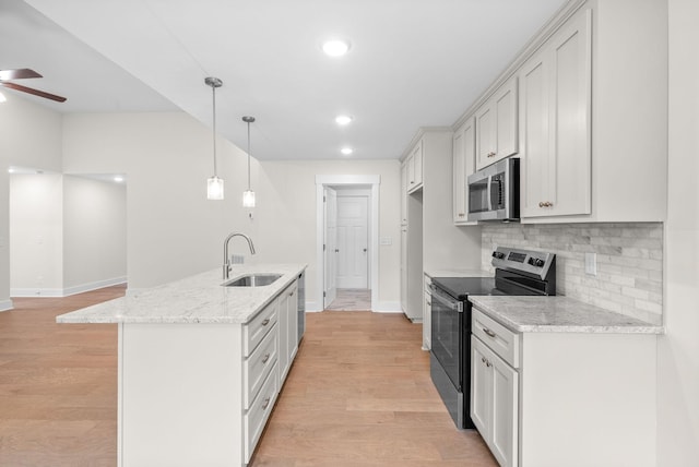 1928 Flats Rd, Cunningham, TN 37052 - kitchen with stainless steel appliances, a sink, baseboards, ceiling fan, and tasteful backsplash