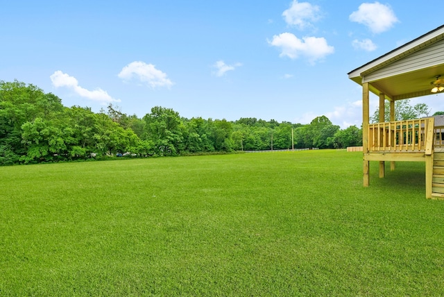 1928 Flats Rd, Cunningham, TN 37052 - view of green lawn featuring a wooden deck and a ceiling fan