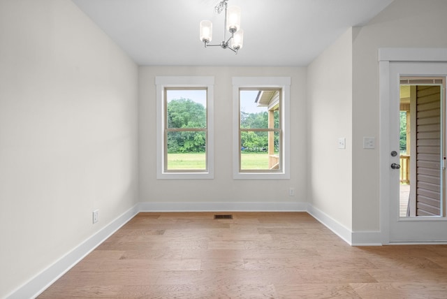 1928 Flats Rd, Cunningham, TN 37052 - unfurnished dining area with a chandelier, light wood finished floors, and baseboards