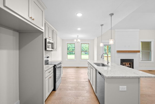 1928 Flats Rd, Cunningham, TN 37052 - kitchen featuring appliances with stainless steel finishes, a sink, light wood finished floors, plenty of natural light, and recessed lighting
