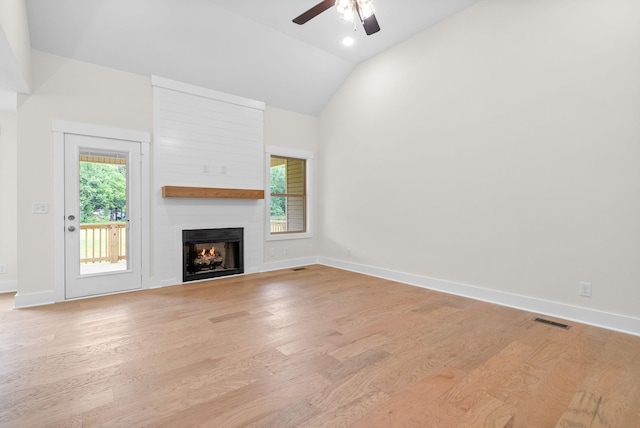1928 Flats Rd, Cunningham, TN 37052 - unfurnished living room featuring lofted ceiling, a ceiling fan, light wood finished floors, a fireplace, and baseboards