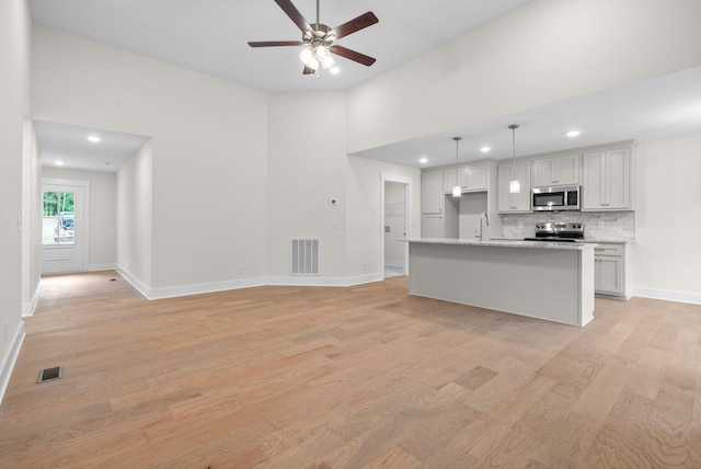1928 Flats Rd, Cunningham, TN 37052 - kitchen featuring stainless steel appliances, light wood-style floors, recessed lighting, a ceiling fan, and tasteful backsplash
