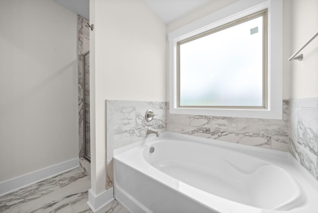 1928 Flats Rd, Cunningham, TN 37052 - bathroom featuring a garden tub, marble look tiles, baseboards, and a shower stall