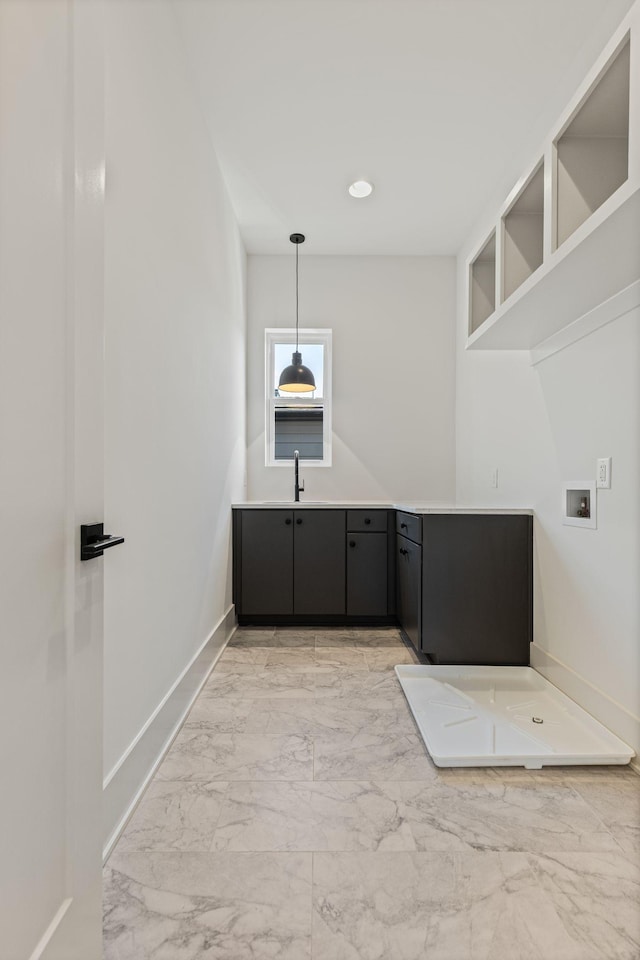 2801B W Kirkwood Ave, Nashville, TN 37204 - laundry area featuring cabinet space, washer hookup, light marble finish floors, and baseboards