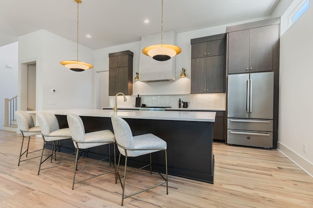 2801B W Kirkwood Ave, Nashville, TN 37204 - kitchen featuring stainless steel refrigerator, a sink, light countertops, an island with sink, and a breakfast bar