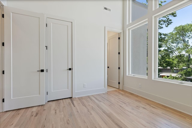 2801B W Kirkwood Ave, Nashville, TN 37204 - unfurnished bedroom featuring multiple windows, light wood-type flooring, and baseboards