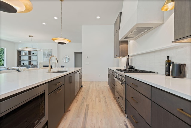 2801B W Kirkwood Ave, Nashville, TN 37204 - kitchen with a sink, stainless steel appliances, light countertops, premium range hood, and light wood-style flooring