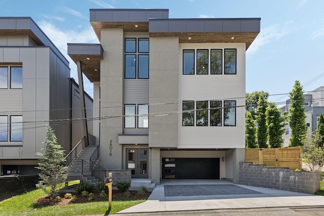 2801B W Kirkwood Ave, Nashville, TN 37204 - modern home featuring driveway, an attached garage, stucco siding, and stairs