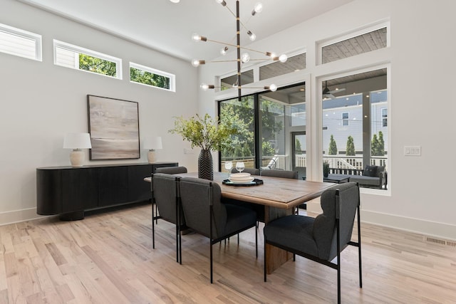 2801B W Kirkwood Ave, Nashville, TN 37204 - dining area with plenty of natural light, light wood-style floors, a chandelier, and a towering ceiling