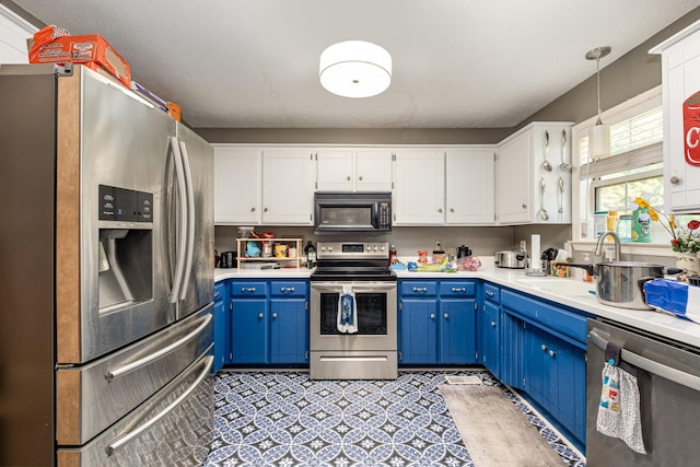 124 Gale Ln, La Vergne, TN 37086 - kitchen featuring appliances with stainless steel finishes, blue cabinets, light countertops, white cabinets, and pendant lighting
