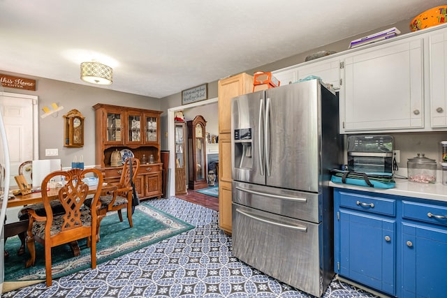 124 Gale Ln, La Vergne, TN 37086 - kitchen featuring stainless steel refrigerator with ice dispenser, blue cabinets, light countertops, and white cabinets
