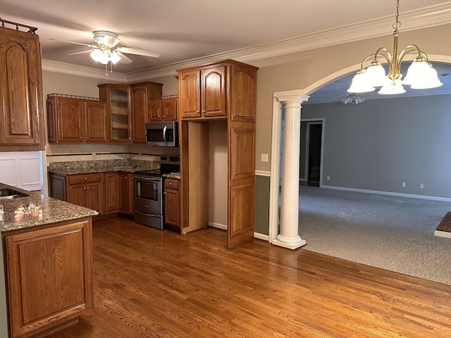 95 Dundee Cir, Mcminnville, TN 37110 - kitchen featuring appliances with stainless steel finishes, a chandelier, a ceiling fan, decorative columns, and arched walkways
