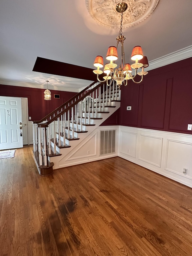 95 Dundee Cir, Mcminnville, TN 37110 - stairway with a chandelier, a decorative wall, wood finished floors, and crown molding