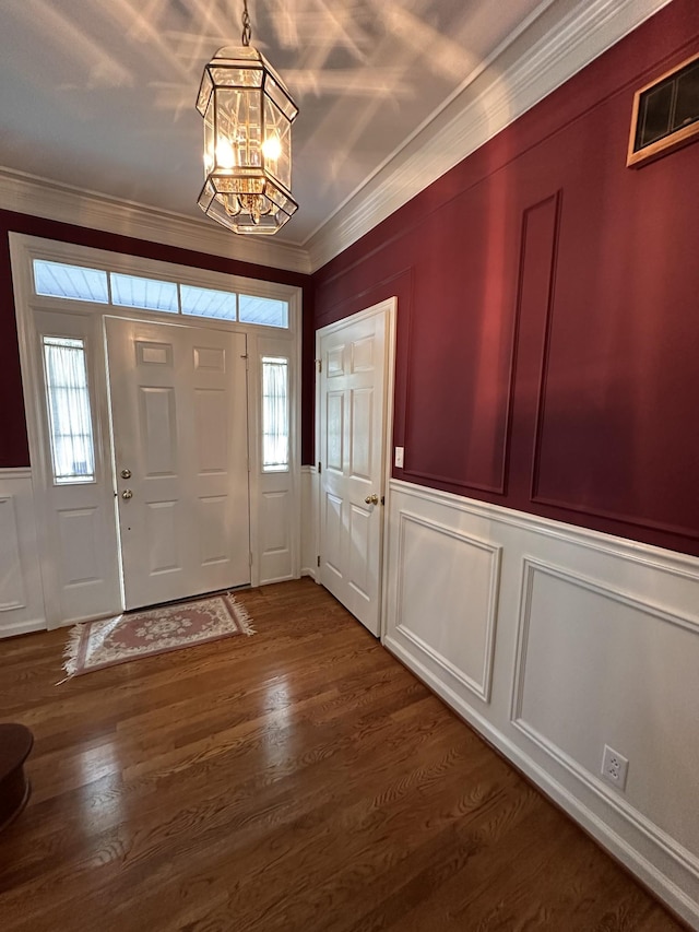 95 Dundee Cir, Mcminnville, TN 37110 - entryway with a decorative wall, ornamental molding, a chandelier, dark wood-type flooring, and a wainscoted wall