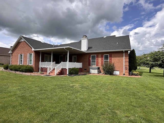 95 Dundee Cir, Mcminnville, TN 37110 - rear view of house with brick siding, a porch, a yard, and a chimney