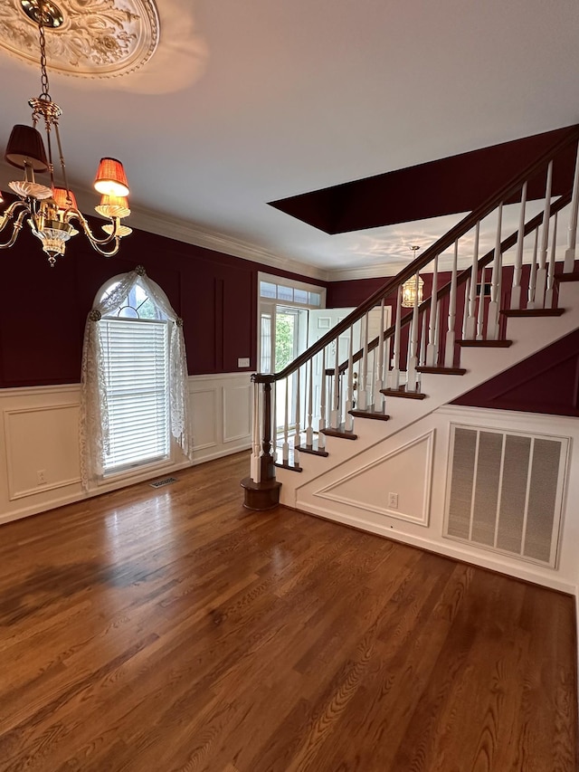 95 Dundee Cir, Mcminnville, TN 37110 - stairway featuring a decorative wall, a chandelier, crown molding, wood finished floors, and a wainscoted wall