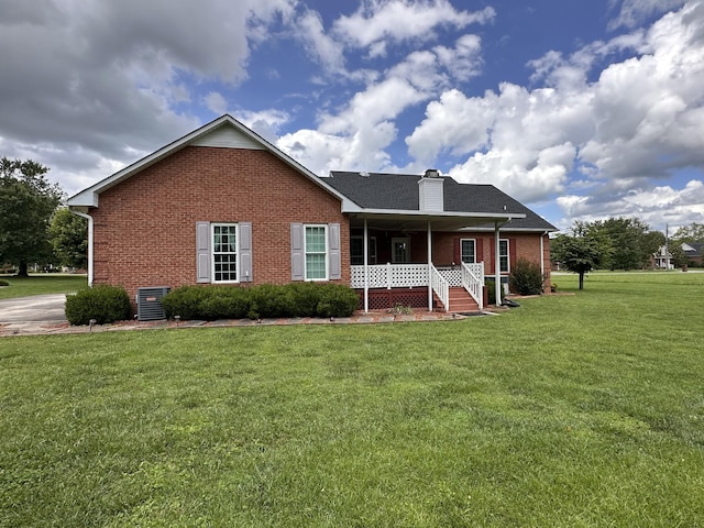 95 Dundee Cir, Mcminnville, TN 37110 - view of front of house featuring brick siding, covered porch, a front yard, central air condition unit, and a chimney