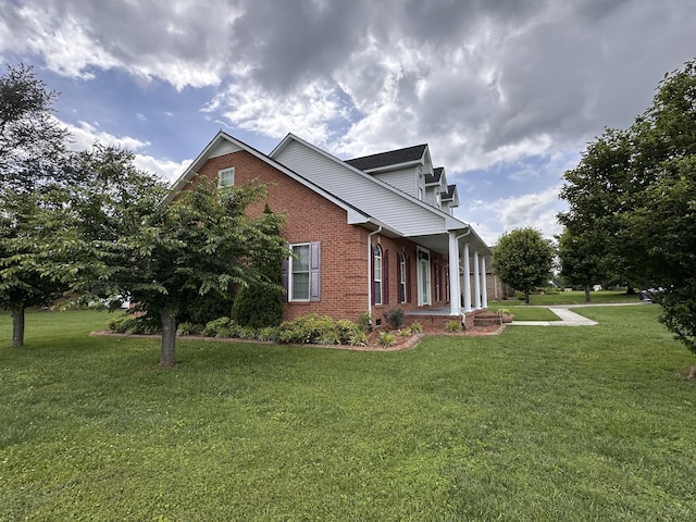 95 Dundee Cir, Mcminnville, TN 37110 - view of side of property featuring brick siding, a yard, and a porch