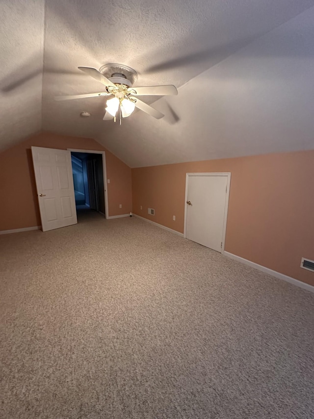 95 Dundee Cir, Mcminnville, TN 37110 - bonus room featuring vaulted ceiling, light colored carpet, ceiling fan, baseboards, and a textured ceiling