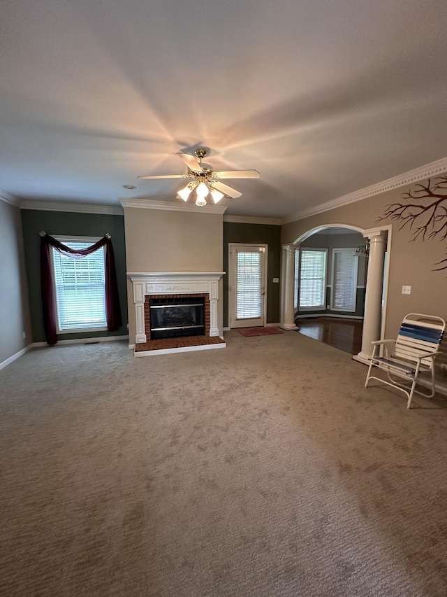 95 Dundee Cir, Mcminnville, TN 37110 - unfurnished living room with carpet flooring, a brick fireplace, ceiling fan, crown molding, and plenty of natural light