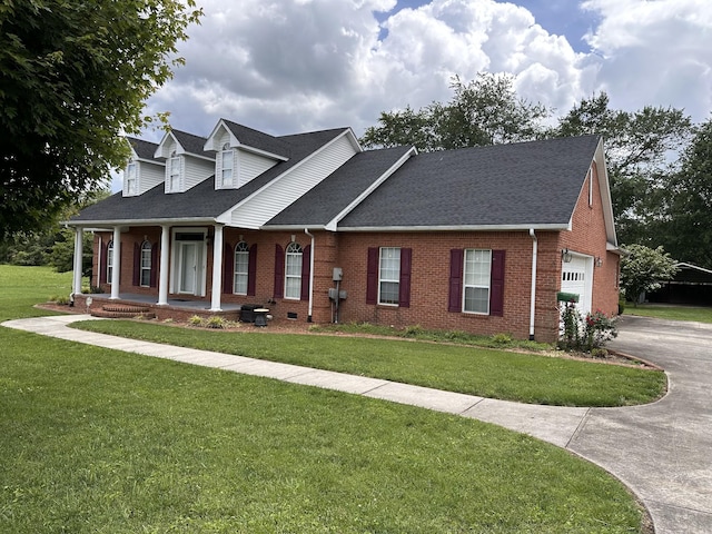 95 Dundee Cir, Mcminnville, TN 37110 - cape cod house featuring brick siding, covered porch, and a front lawn