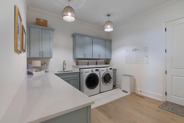 4761 Woodrow Pl, Arrington, TN 37014 - laundry room featuring independent washer and dryer, cabinet space, light wood-type flooring, ornamental molding, and baseboards