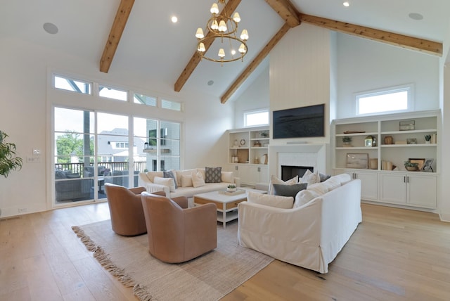 4761 Woodrow Pl, Arrington, TN 37014 - living area with high vaulted ceiling, beamed ceiling, light wood-style flooring, a chandelier, and a brick fireplace