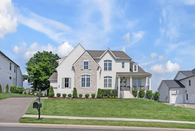 4761 Woodrow Pl, Arrington, TN 37014 - view of front of home with stone siding, a front yard, and a porch