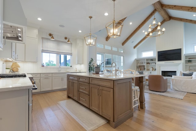 4761 Woodrow Pl, Arrington, TN 37014 - kitchen featuring open floor plan, light wood-style flooring, light countertops, white cabinetry, and a chandelier