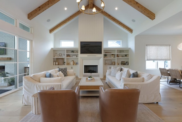4761 Woodrow Pl, Arrington, TN 37014 - living area featuring a large fireplace, high vaulted ceiling, beam ceiling, light wood-type flooring, and a chandelier