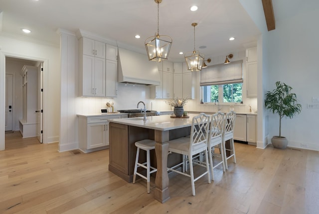 4761 Woodrow Pl, Arrington, TN 37014 - kitchen with white dishwasher, recessed lighting, a kitchen island with sink, custom range hood, and a breakfast bar
