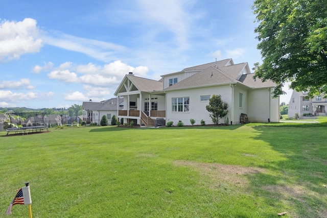 4761 Woodrow Pl, Arrington, TN 37014 - rear view of house with a trampoline, a yard, cooling unit, and stairs