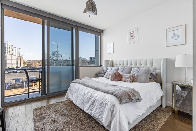1212 Laurel St Unit 206, Nashville, TN 37203 - bedroom with access to outside, wood finished floors, and a city view