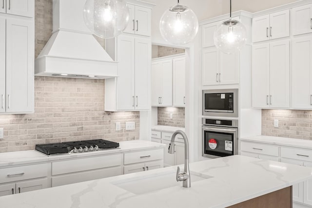 7503 Old Nashville Rd, Fairview, TN 37062 - kitchen featuring appliances with stainless steel finishes, custom range hood, backsplash, and white cabinetry
